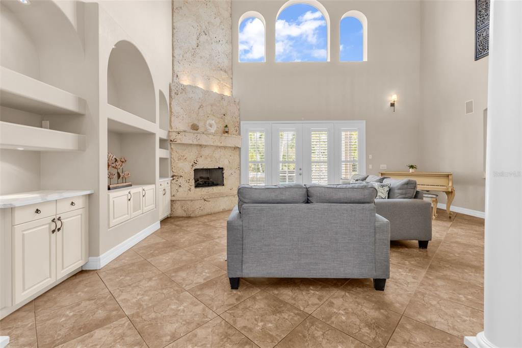 5595 Riverside Drive Punta Gorda, FL 33982 - Photo 13 of 78 a living room with furniture a fireplace and a chandelier