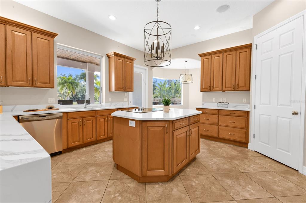 5595 Riverside Drive Punta Gorda, FL 33982 - Photo 2 of 78 a kitchen with stainless steel appliances granite countertop a sink dishwasher stove and refrigerator with wooden floor