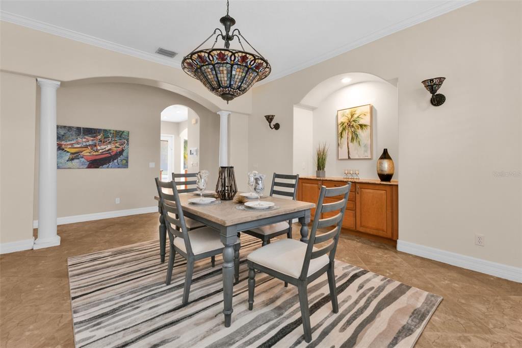 5595 Riverside Drive Punta Gorda, FL 33982 - Photo 26 of 78 a view of a dining room with furniture and a chandelier