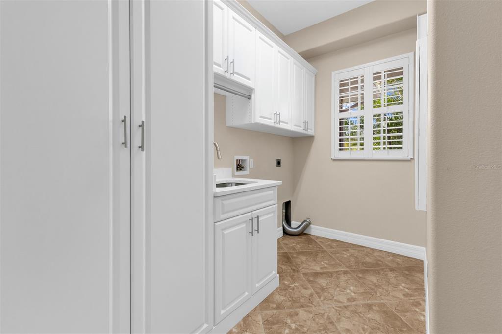 5595 Riverside Drive Punta Gorda, FL 33982 - Photo 36 of 78 a utility room with cabinets washer and dryer