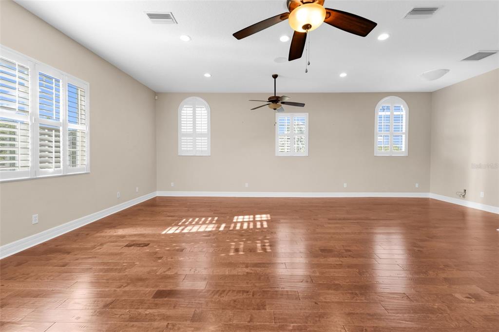 5595 Riverside Drive Punta Gorda, FL 33982 - Photo 37 of 78 a view of an empty room with wooden floor and a window