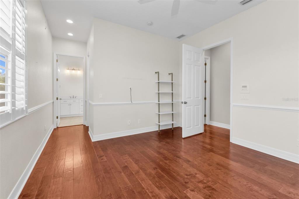 5595 Riverside Drive Punta Gorda, FL 33982 - Photo 48 of 78 an empty room with wooden floor and windows