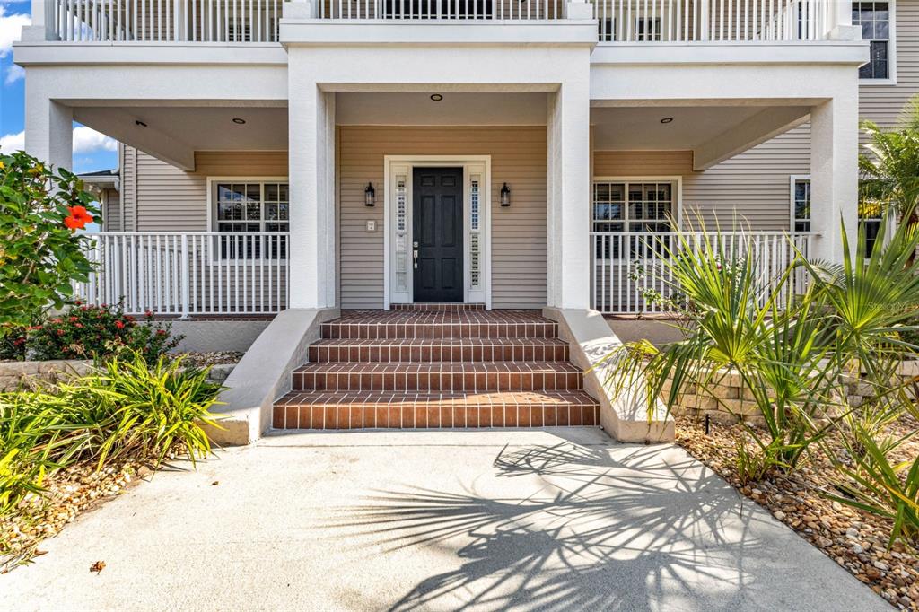 5595 Riverside Drive Punta Gorda, FL 33982 - Photo 5 of 78 a front view of a house with a garden