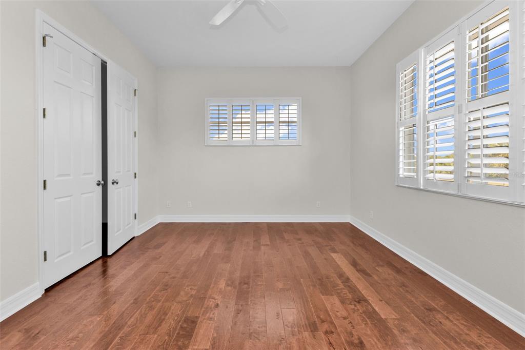 5595 Riverside Drive Punta Gorda, FL 33982 - Photo 53 of 78 a view of an empty room with wooden floor and a window