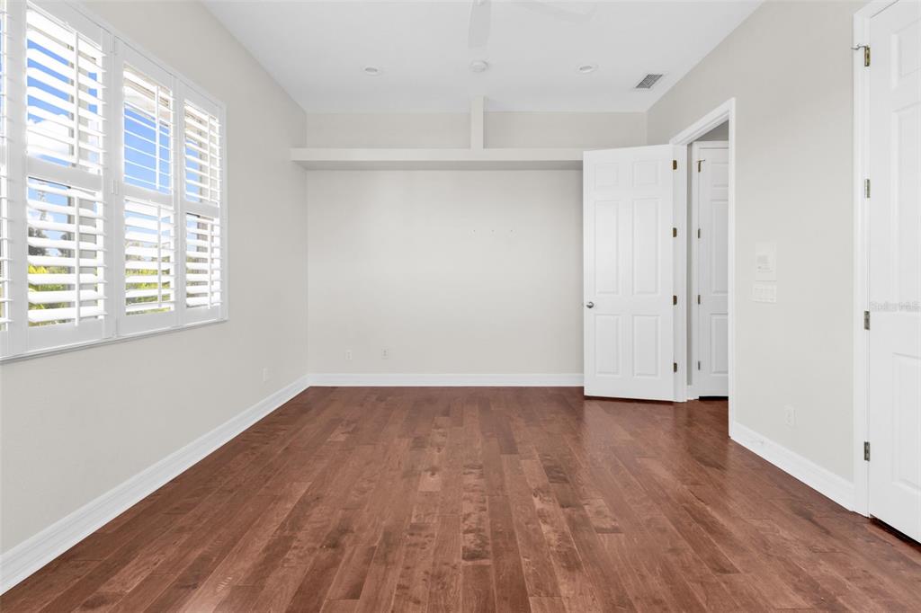 5595 Riverside Drive Punta Gorda, FL 33982 - Photo 54 of 78 a view of an empty room with wooden floor and a window