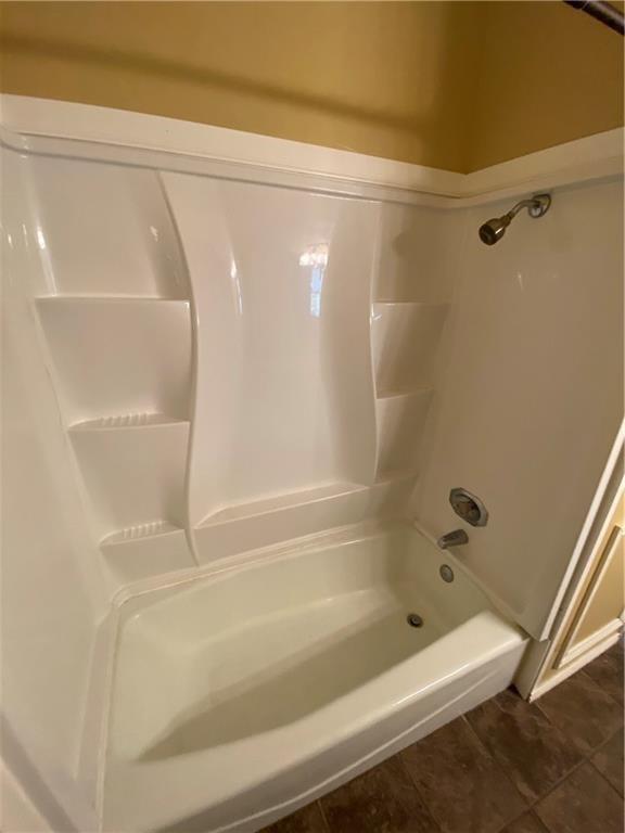 2802 Nueces Street, Unit 311 Austin, TX 78705 - Photo 12 of 13 a bathroom with a shower and a bath tub