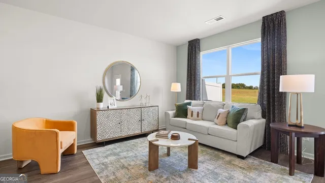 a living room with furniture and a window