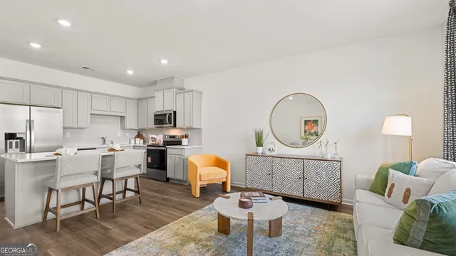 a living room with furniture a mirror and a table