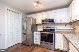 1204 Mountainview Drive Chesterbrook, PA 19087 - Photo 15 of 25 a kitchen with stainless steel appliances granite countertop a stove a refrigerator and a microwave