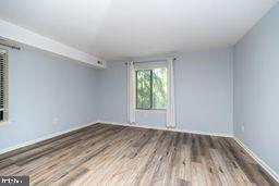 1204 Mountainview Drive Chesterbrook, PA 19087 - Photo 21 of 25 an empty room with wooden floor and windows