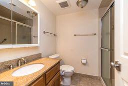 1204 Mountainview Drive Chesterbrook, PA 19087 - Photo 23 of 25 a bathroom with a granite countertop sink toilet and shower