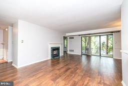 1204 Mountainview Drive Chesterbrook, PA 19087 - Photo 6 of 25 a view of an empty room with wooden floor and a window