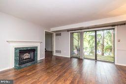 1204 Mountainview Drive Chesterbrook, PA 19087 - Photo 10 of 25 an empty room with wooden floor fireplace and windows