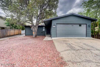 a front view of house with a yard and garage