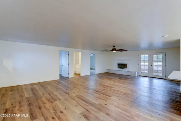 a view of empty room with wooden floor and fireplace