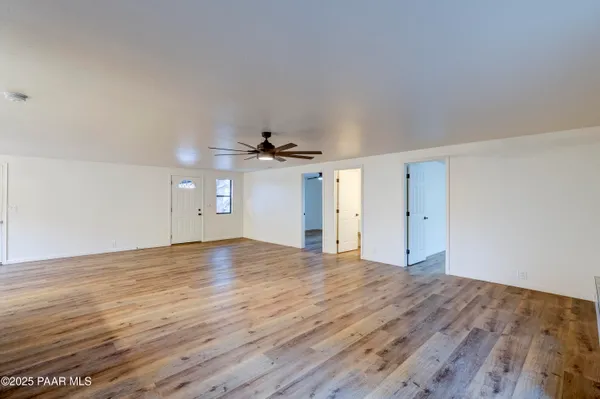 a view of empty room with wooden floor