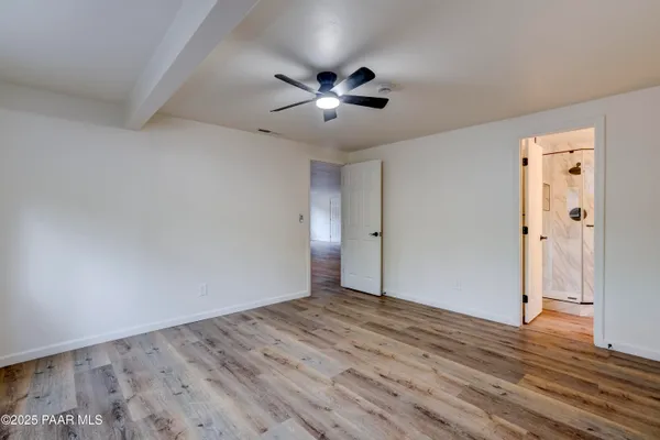 a view of empty room with wooden floor