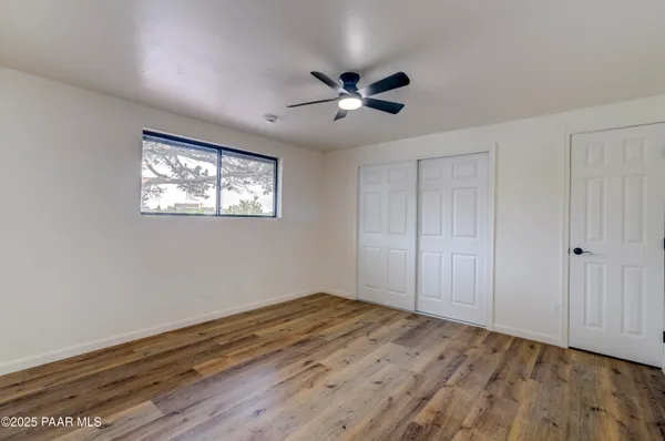 a view of empty room with wooden floor