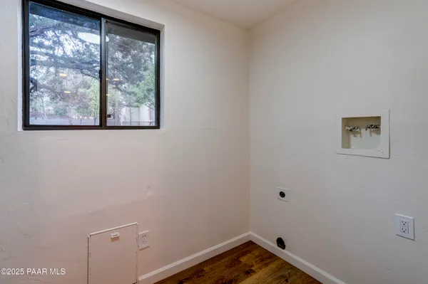 a view of a small space with window and a ceiling fan