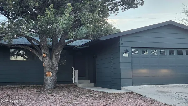 a tree in front of a house