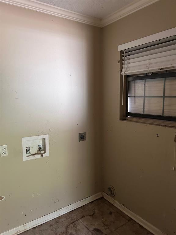 13550 Johns Gin Road Keithville, LA 71047 - Photo 5 of 11 Laundry area with crown molding, hookup for a washing machine, a textured ceiling, and electric dryer hookup