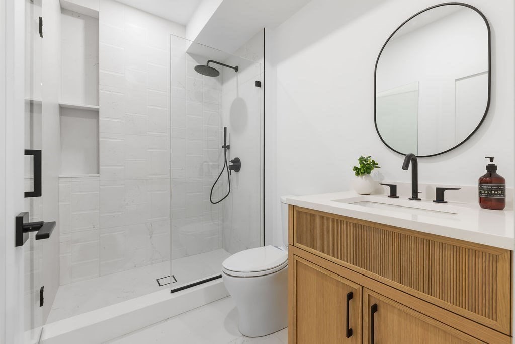 28 Cottonwood Road Newton, MA 02459 - Photo 21 of 25 a bathroom with a sink a toilet and a mirror