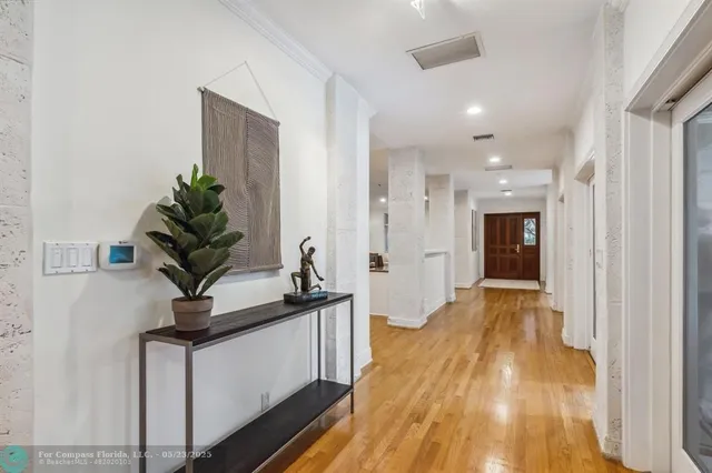 a dining room with furniture wooden floor and a chandelier