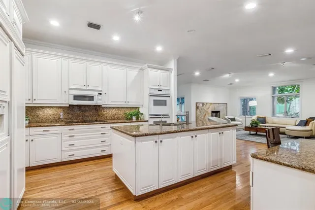 a dining room with furniture a large window and a dining table