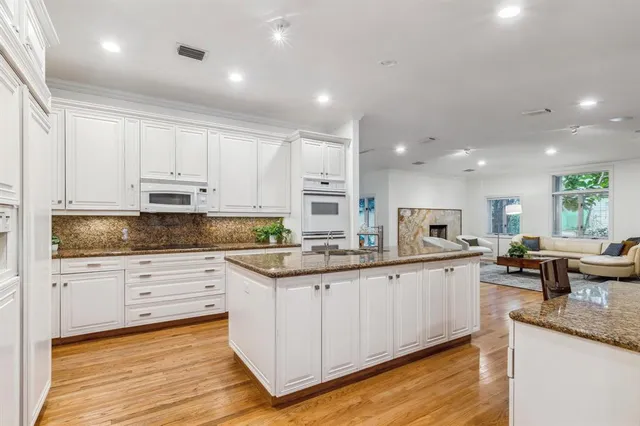 a bathroom with a granite countertop sink a toilet and a mirror