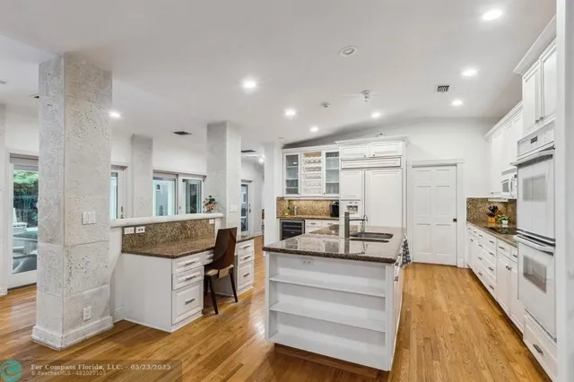 a bathroom with a granite countertop sink a toilet and a mirror