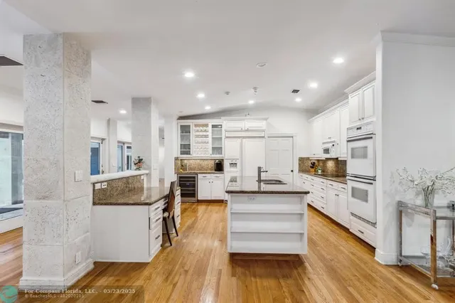 a living room with fireplace furniture and a large window