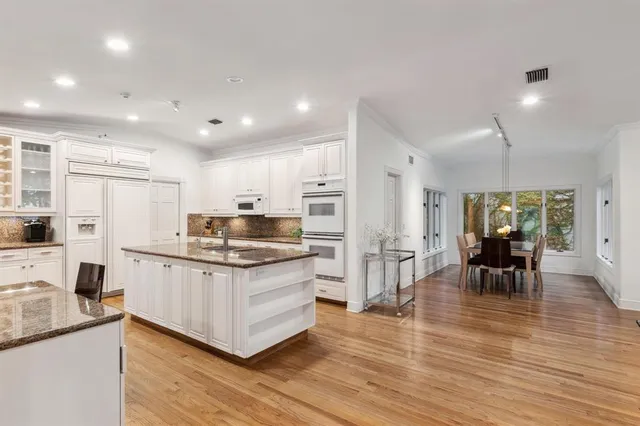 a bedroom with a bed a flat screen tv and chandelier