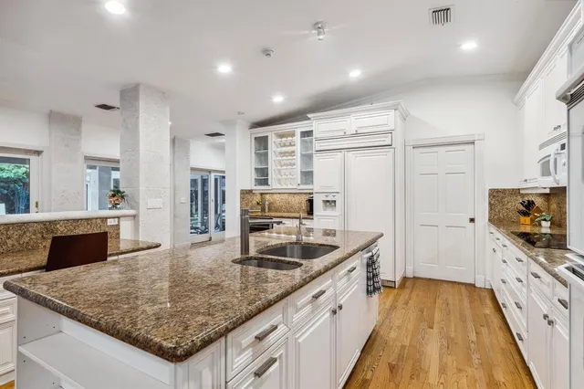 a bathroom with a toilet a sink a mirror and vanity