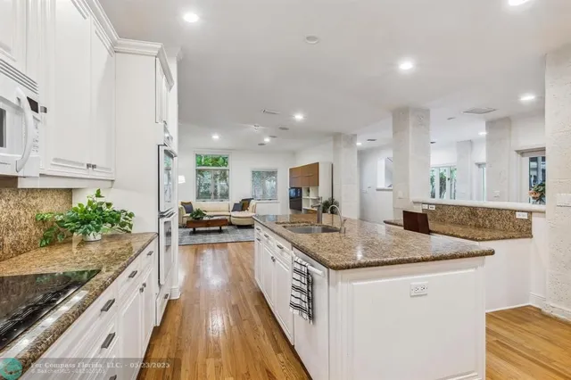 a living room with furniture and a dining table with kitchen view