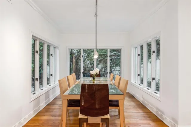 a bedroom with a large bed and a potted plant
