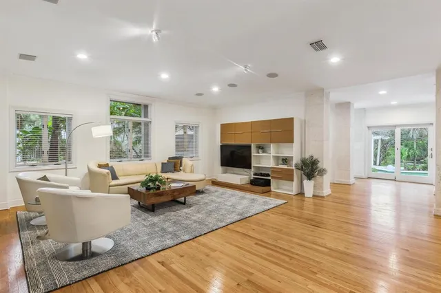 a view of a work space with furniture and wooden floor