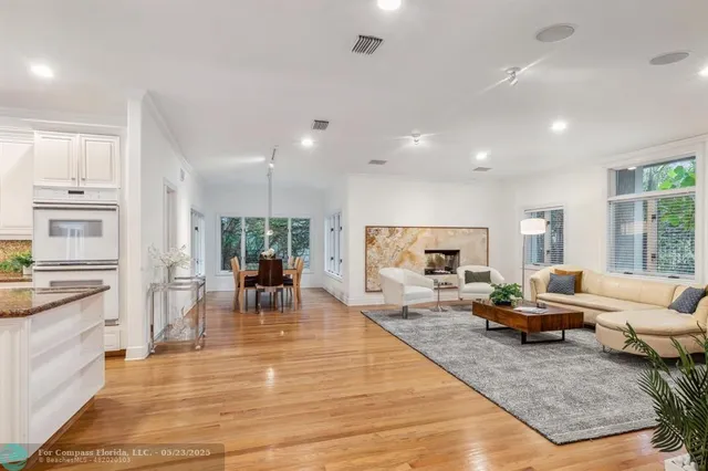 a bedroom with a bed wooden floor and a flat screen tv
