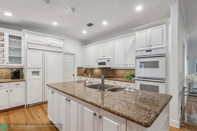 a spacious bathroom with a granite countertop sink mirror and a shower