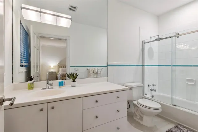 a spacious bedroom with a large bed and a large window