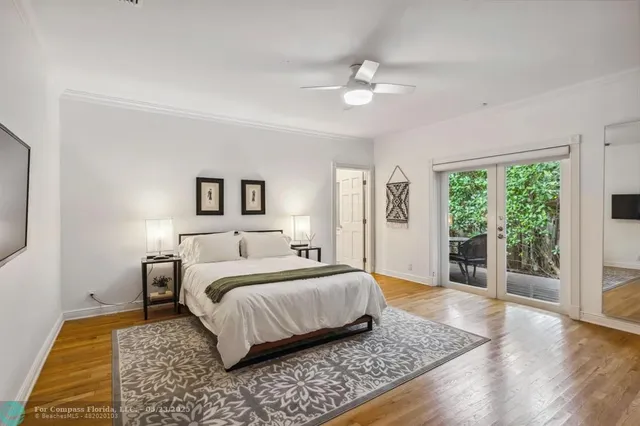 a white vase with white and yellow flowers