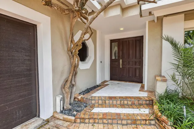 a kitchen with stainless steel appliances kitchen island granite countertop a stove and a wooden floors