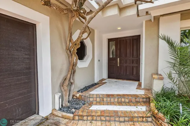 a kitchen with stainless steel appliances kitchen island granite countertop a refrigerator and a stove top oven