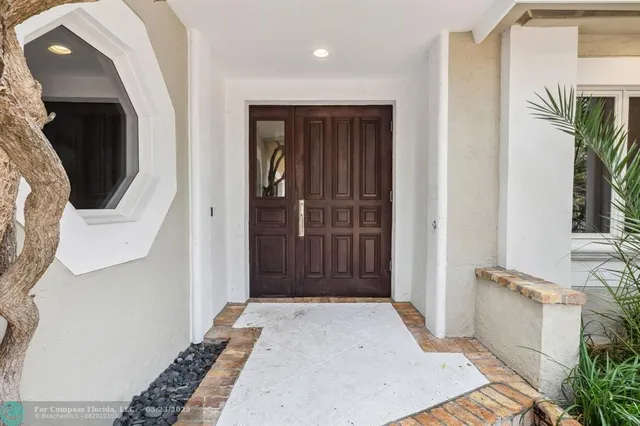 a kitchen with stainless steel appliances kitchen island granite countertop a stove and a wooden floors