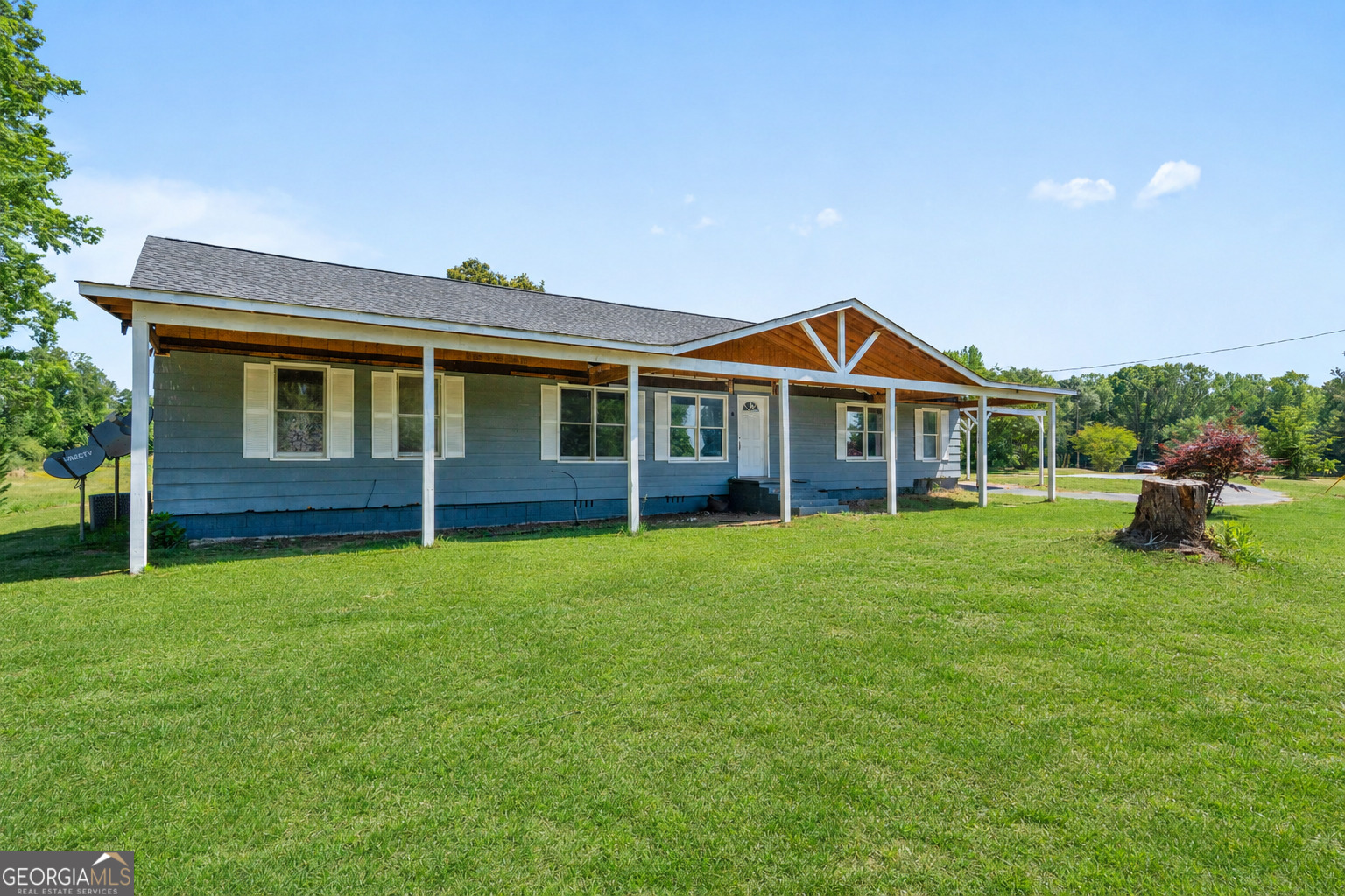 49 Frost Road Bowdon, GA 30108 - Photo 5 of 60 a front view of a house with a garden