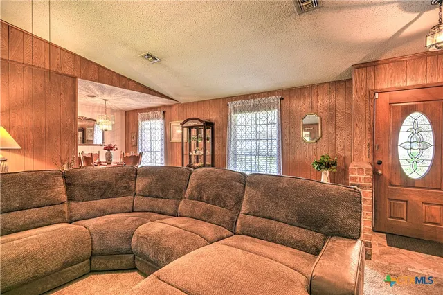 a living room with furniture a couch and a window