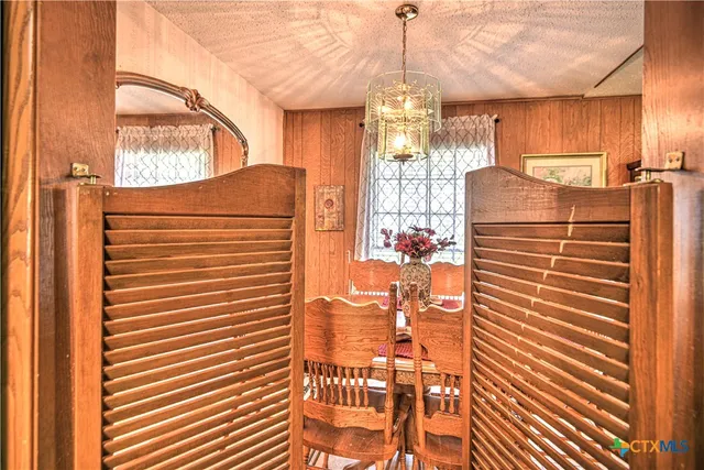 a view of kitchen with refrigerator and cabinets