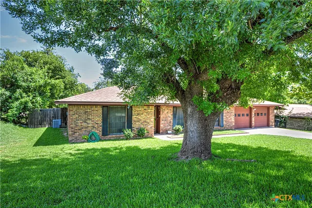a view of a house with a yard and porch