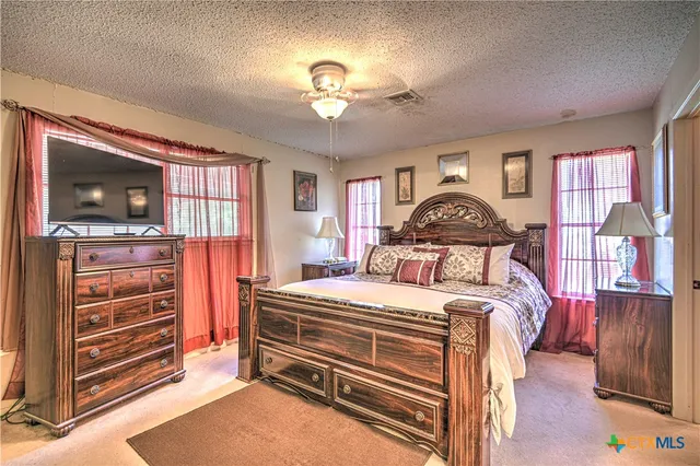 a bedroom with a bed and a television