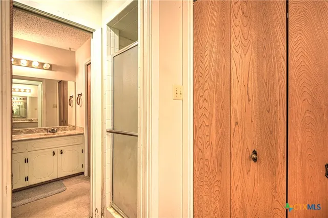 a bathroom with a double vanity sink and a mirror