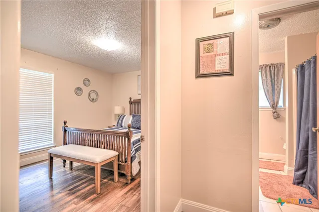 a bedroom with furniture and a window